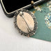 Vintage micro mosaic brooch on an old postcard