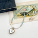 Pearl and larimar necklace with a vintage  heart-shaped mother of pearl and gold locket on an old box and fan illustration