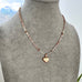 Necklace with a heart-shaped pendant on a mannequin bust against a neutral background