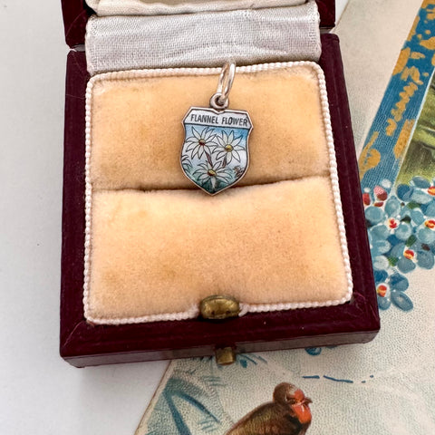Flannel Flower charm  in a jewelry box with floral background