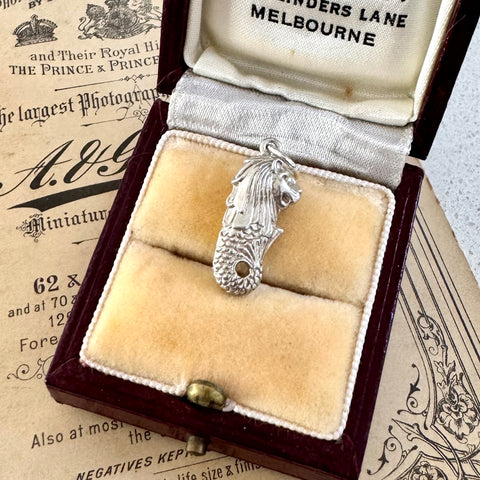 Vintage sterling silver Singapore Merlion charm in an open jewellery box