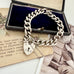 Vonk Jewellery heavy sterling silver curb link chain bracelet with heart padlock clasp on vintage postcards and with a vintage jewellery box