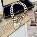 Vonk Jewellery heavy sterling silver curb link chain bracelet with heart padlock clasp on vintage postcards and with a vintage jewellery box