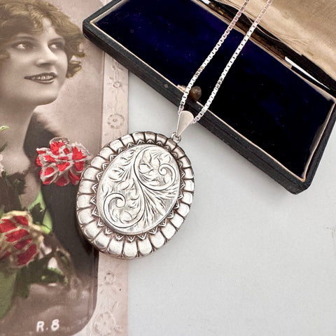 Vonk Jewellery large vintage 1977 sterling silver locket on a vintage postcard and with a vintage jewellery box